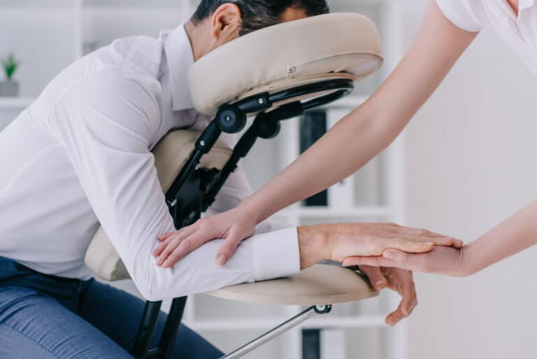 masseuse doing arm massage for businessman at offi 2024 11 13 14 50 07 utc scaled